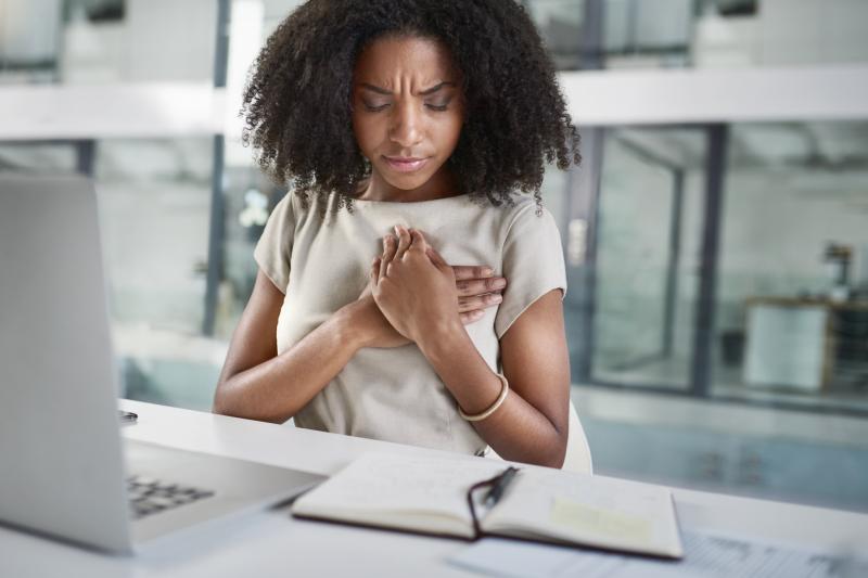 A young woman experiencing chest pain.