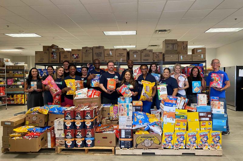 Texas Health Hospital Mansfield team and Mansfield Mission Center pose with 33,746 servings of cereal.