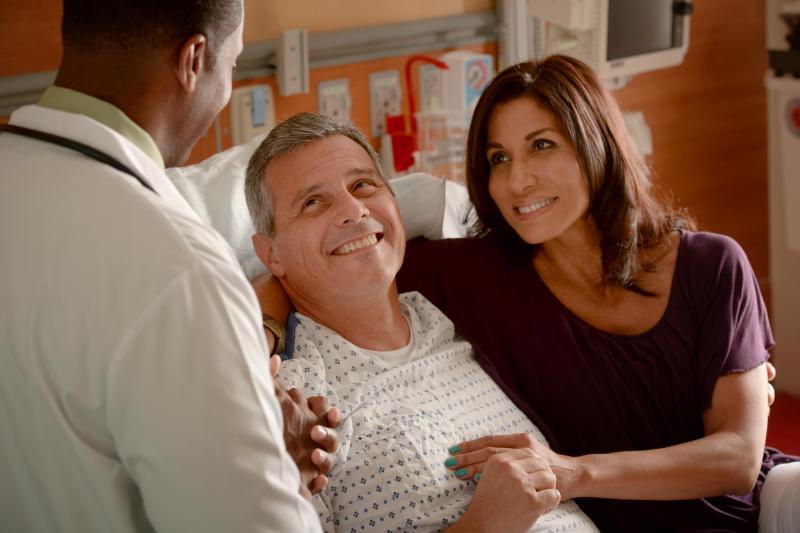 Supportive AdventHealth doctor with patient and caregiver.