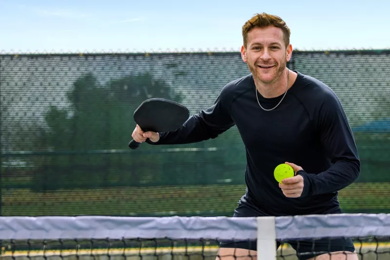 Guy playing pickleball