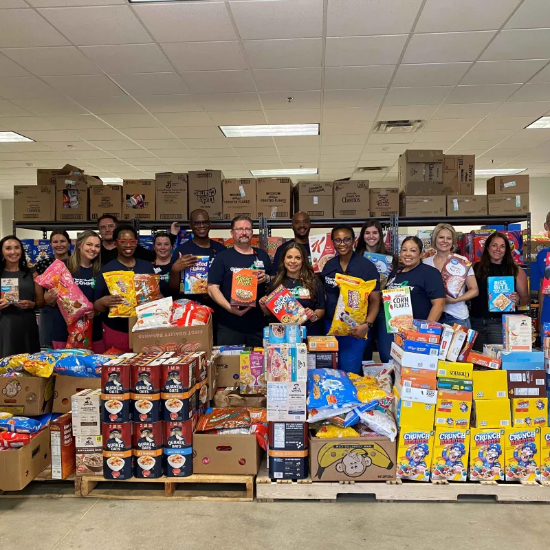 Texas Health Hospital Mansfield team and Mansfield Mission Center pose with 33,746 servings of cereal.