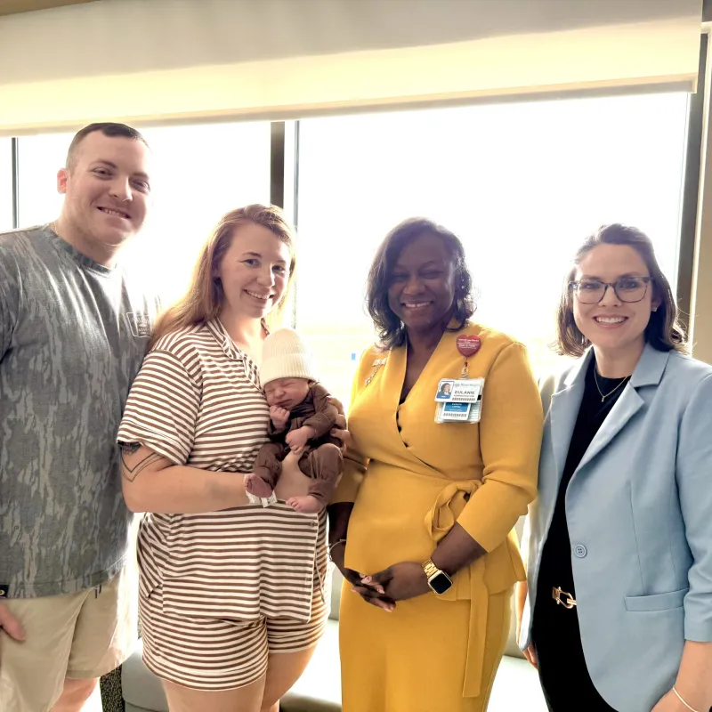 President and CMO of Texas Health Hospital Mansfield standing with the family of an unforgettable birth story