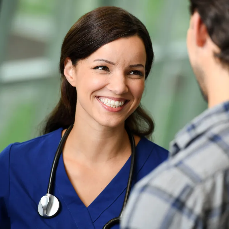 A nurse talking to a patient at the hospital.