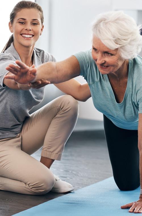 A woman works with a physical therapist.