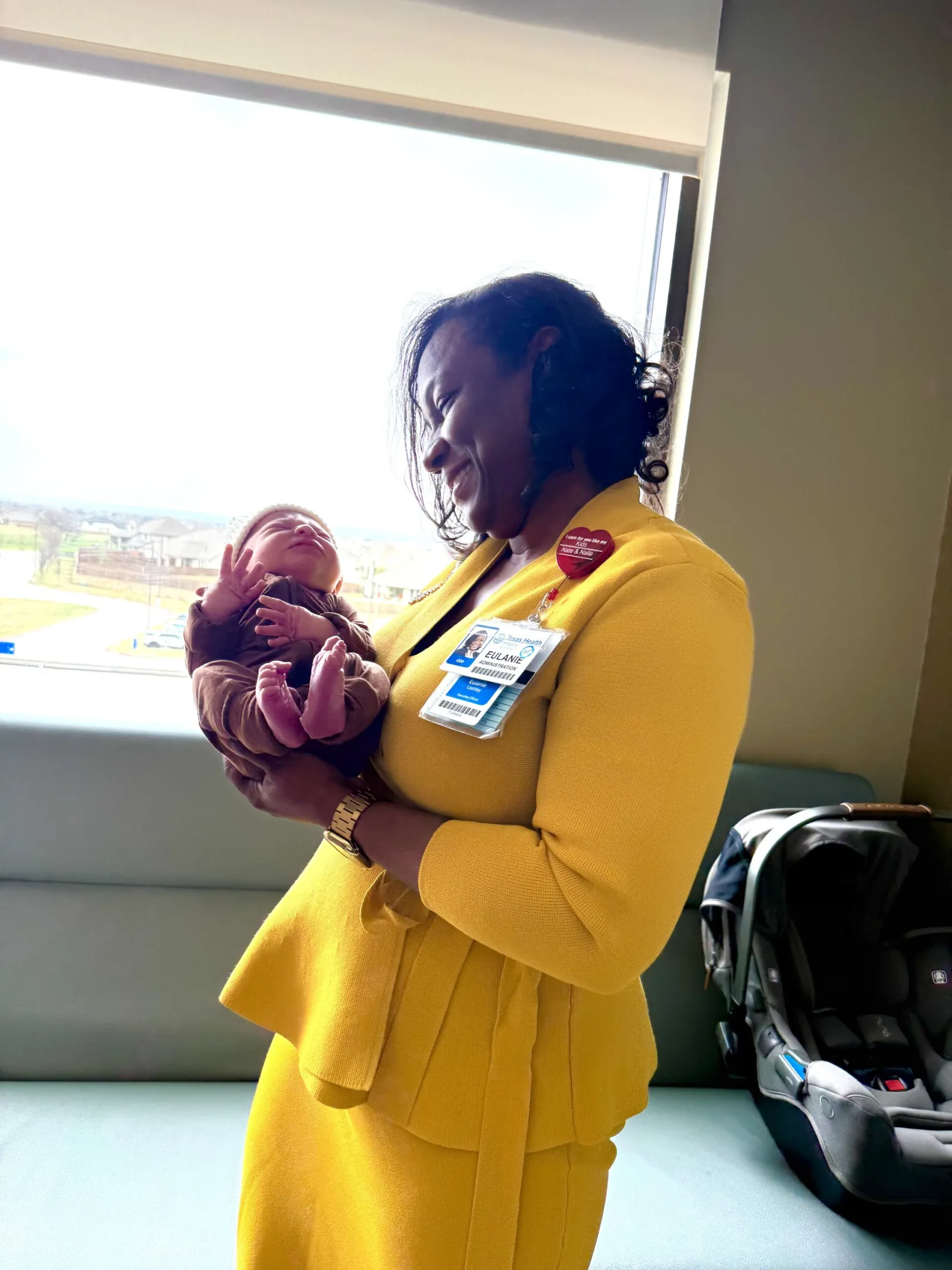 President and CEO of Texas Health Hospital Mansfield holding the baby