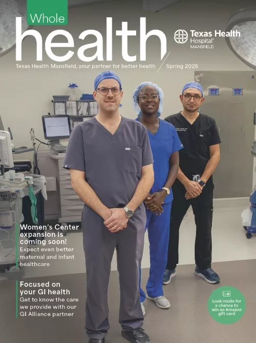 Three Texas Health Mansfield team members standing together in an operating room.